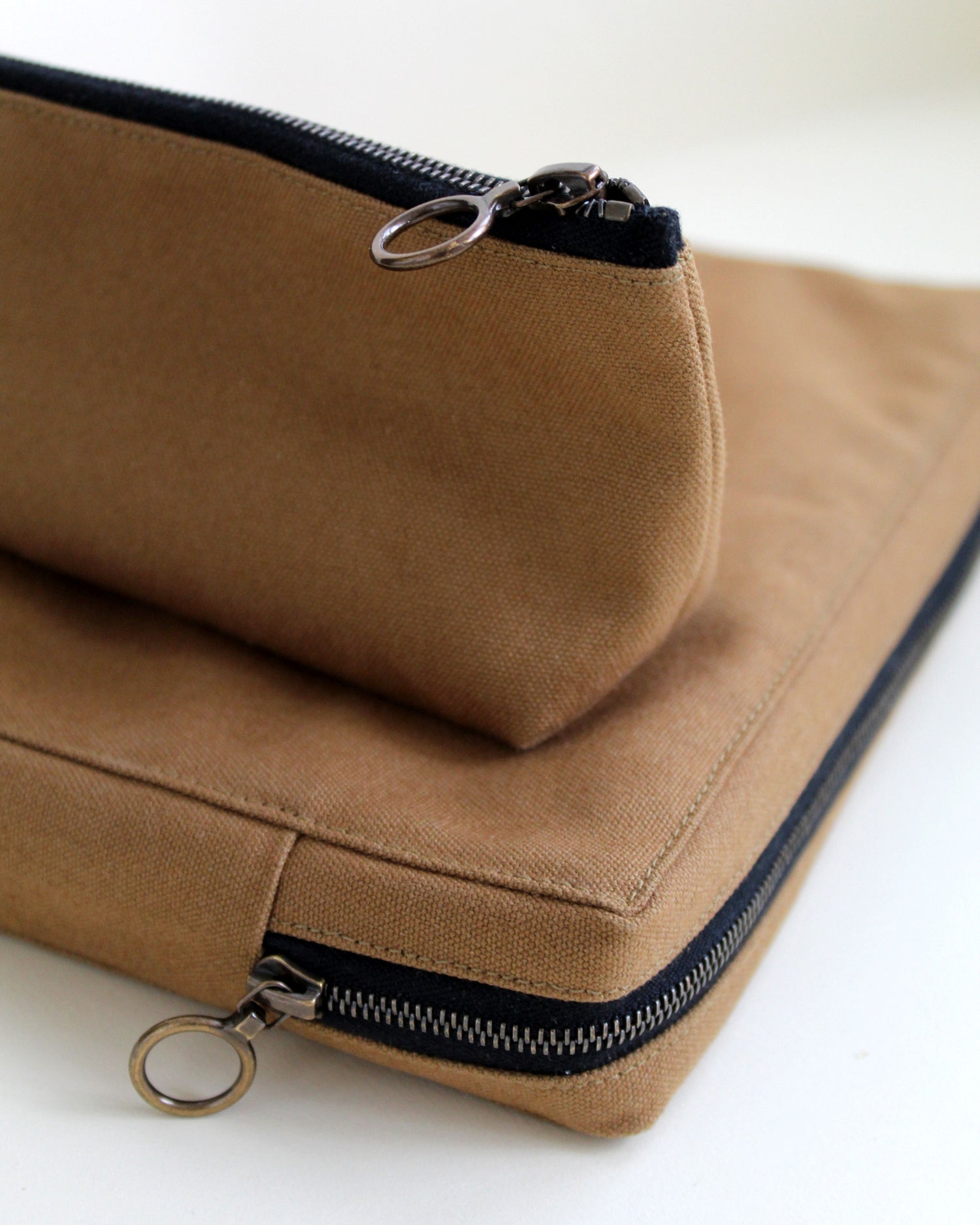 Brown fabric pencil case with zipper on a white background