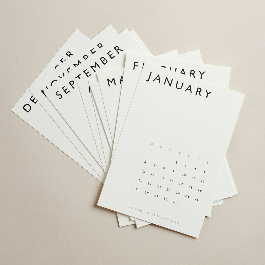 Set of twelve calendar postcards with month names and dates