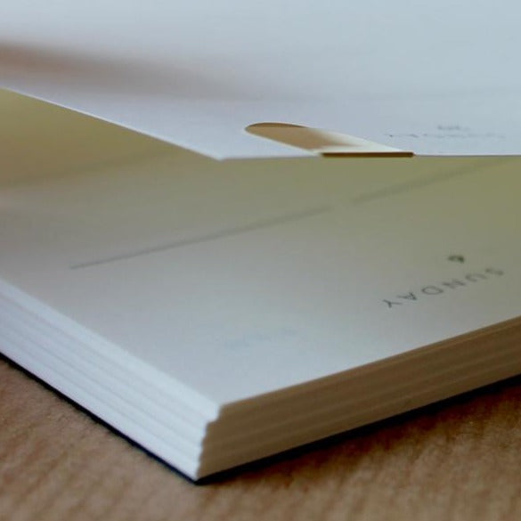 Detail of the Mark+Fold Diary with brass page marker on today's page