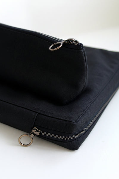 Black canvas pouch with zipper on a white background