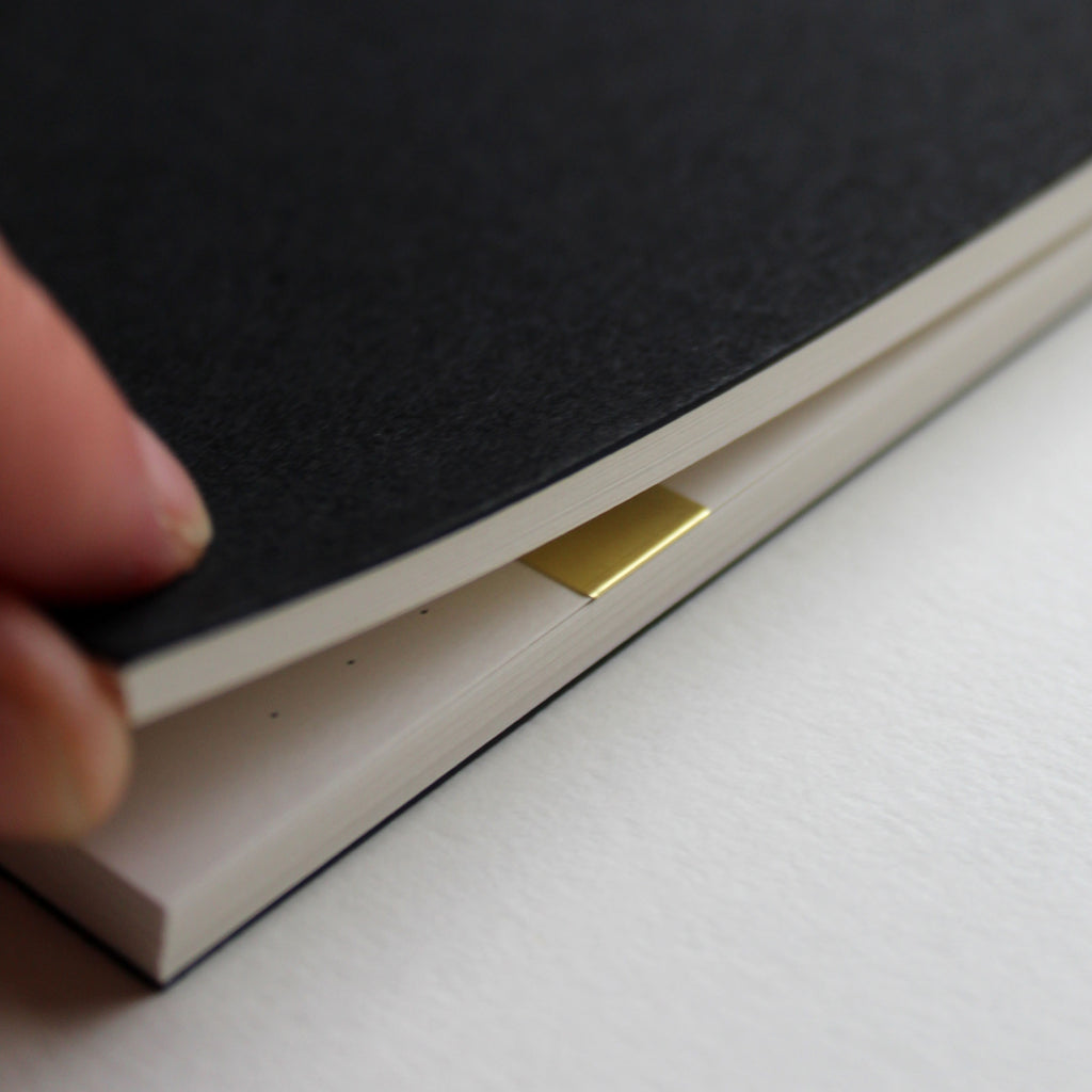 Detail of the Mark+Fold Diary with brass page marker on today's page